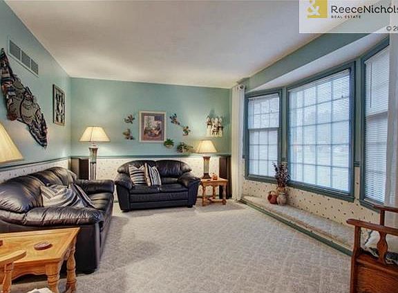 Living room. Could easily be converted into a 3rd bedroom. Hardwood floor under carpet.