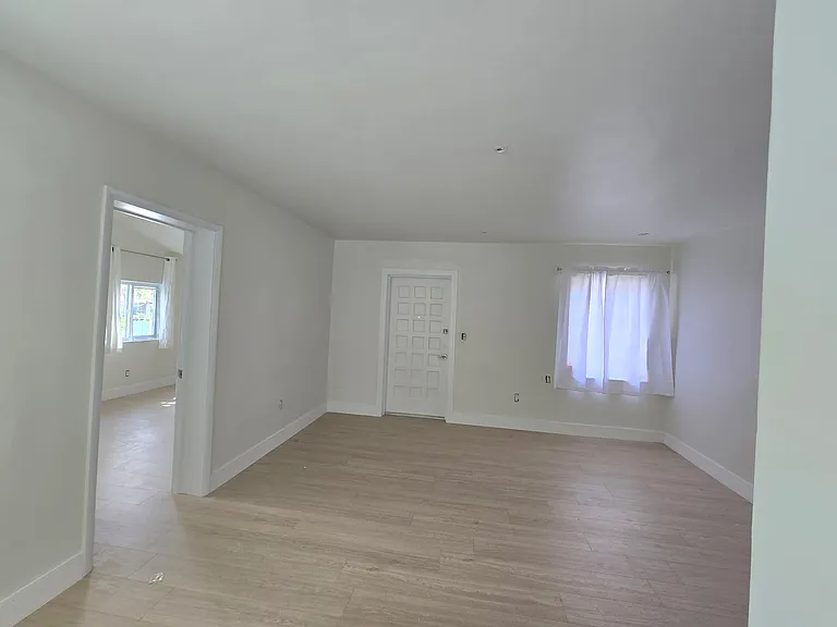 Living room with second bedroom to the left
