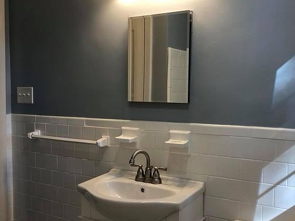 Bathroom 1 has tub with shower