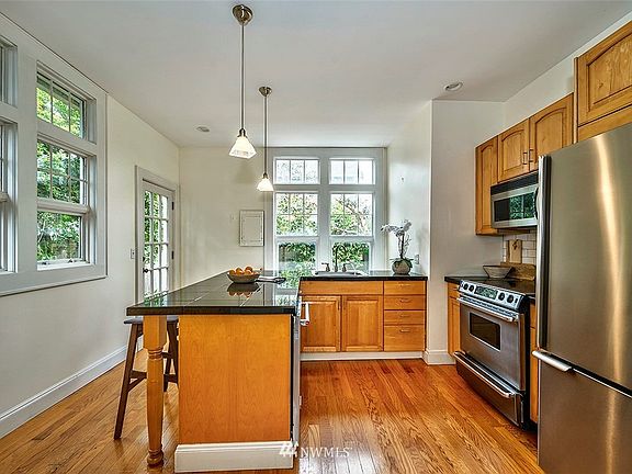 Bright cheery kitchen with second entry and access to the side and back yard. 