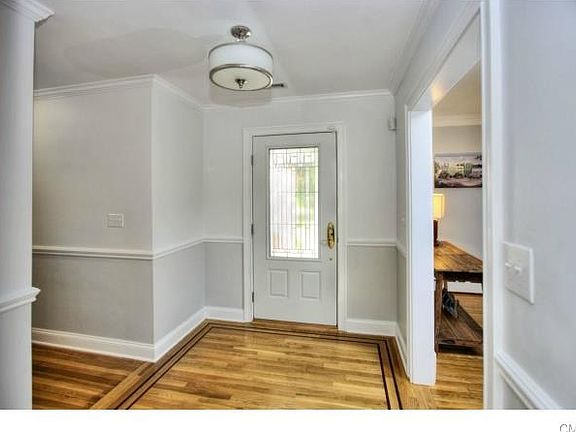 Foyer with inlaid wood floors.