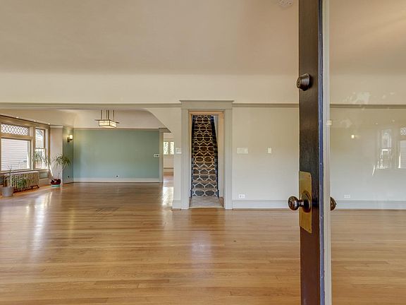 View upon entry - living area, dining room in far left, and stairs going up to second floor
