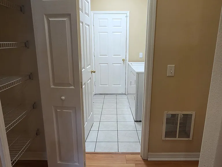 Extra storage space leading to laundry room and to the garage
