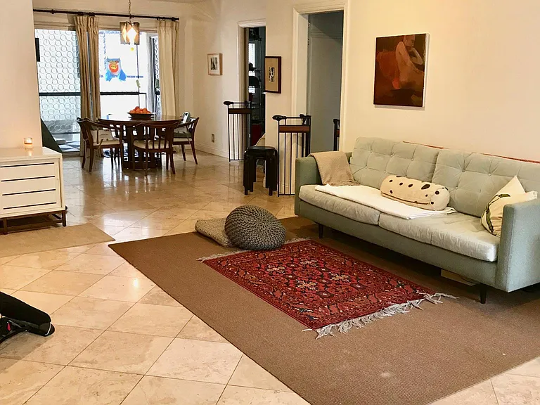 Living room/dining room; view into private patio. Travertine floors