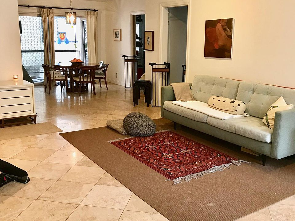 Living room/dining room; view into private patio. Travertine floors