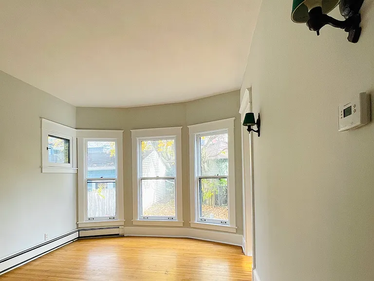 Master bedroom. Custom window treatments provided: beige woven drapes with curtain rods *not photographed*