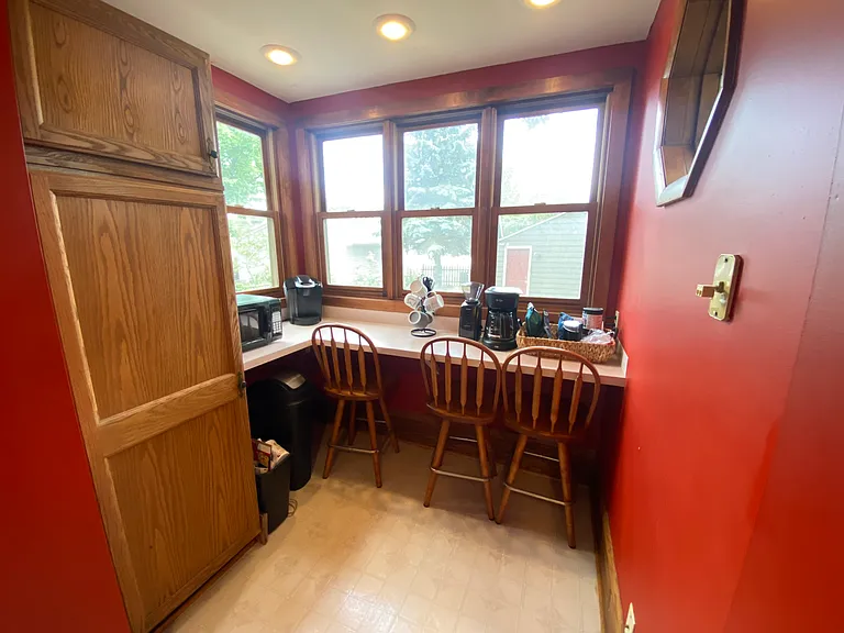 Nook off the kitchen with a raised counter and cabinetry for additional storage!