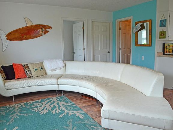 Open living/kitchen/dining concept haslaminate flooring, matching white Frigidaire appliances (2018), ample cabinetry and a great view to the marina.