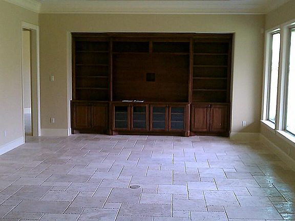 The large family room features a custom built-in entertainment center.