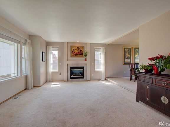 Living room with lots of natural light and gas fireplace. 