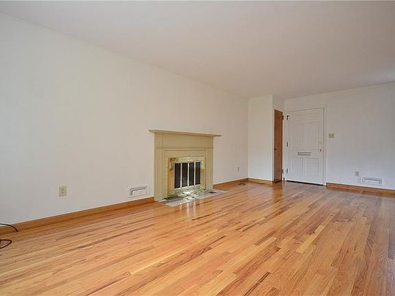 Log burning fireplace with pretty wooden mantle.