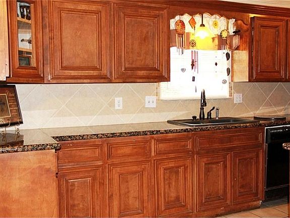 Custom cabinets with lots of storage space, beautiful granite counter tops and tile back splash