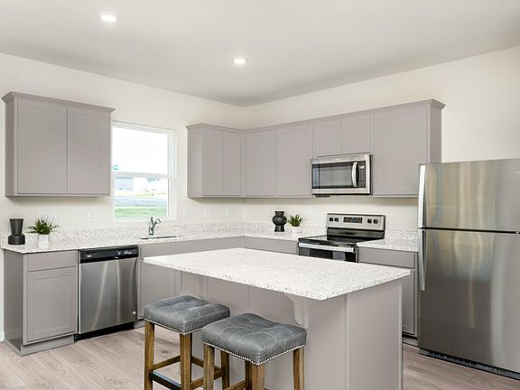 Package B Kitchen with beautiful gray cabinets and quartz countertops.