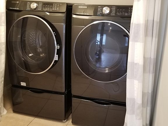 Washer and dryer with storage underneath