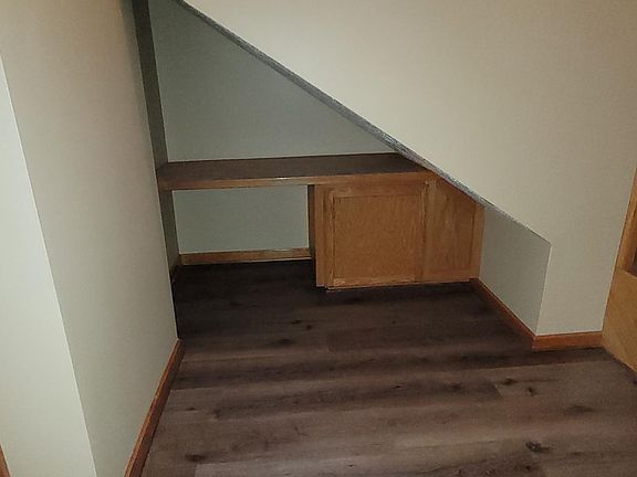 Down stairs - Standing in foyer facing east into Desk area under stair case
