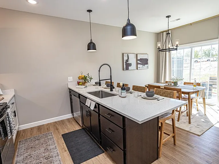 Breakfast bar with trendy pendant lighting, a dishwasher and industrial sink