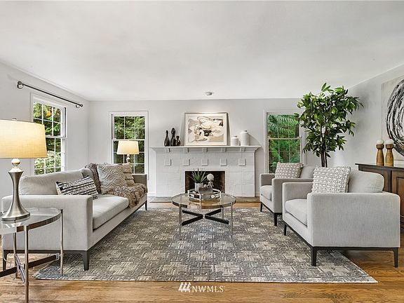 The expansive formal living room off the foyer features a tile surround wood burning fireplace with painted mantle. 