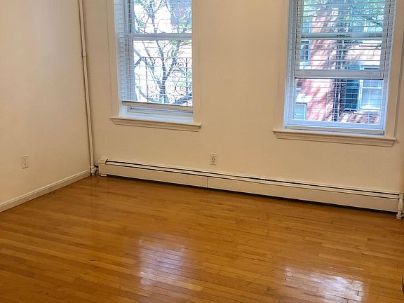 Living room has brand new blinds and has been recently repainted white. It has large windows that face East (morning sun) towards Garden Street and allow much natural light throughout the day.