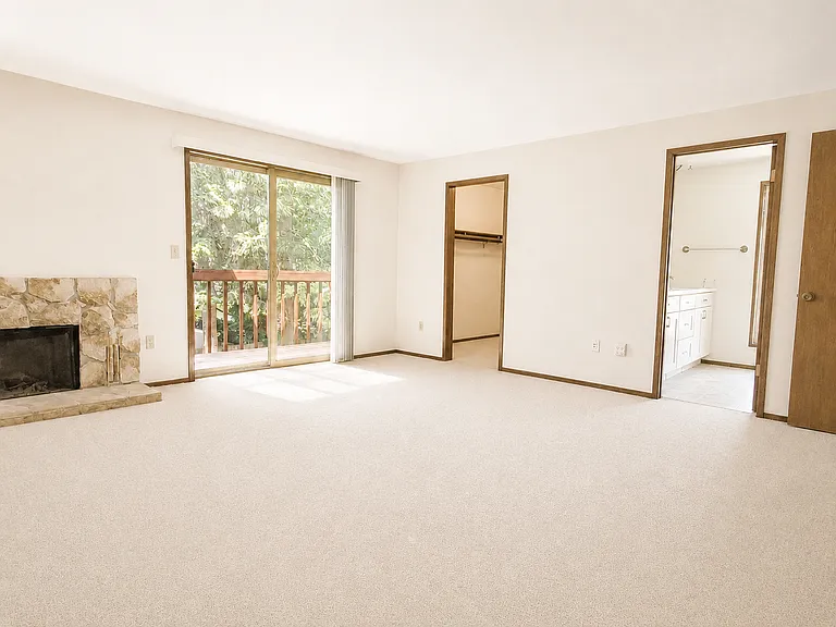 Primary bedroom with a walk-in closet, a dedicated full bathroom, and access to a balcony