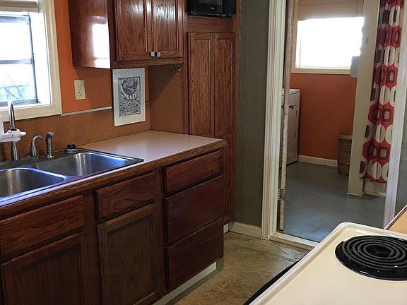 Galley kitchen has all appliances, pots, pans, and microwave plus coffee maker and toaster