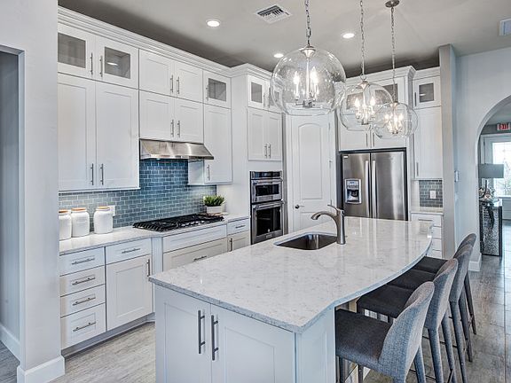 Model Representation Kitchen featuring built-in gas appliances, quartz countertops, and Diamond Vib