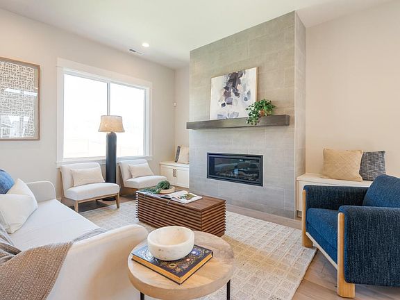 Light and bright great room with fireplace and oversized windows