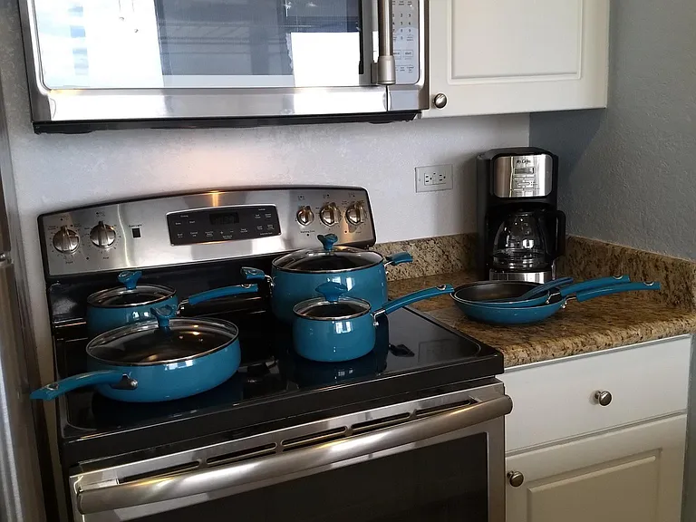 Fully stocked kitchen with cookware, crockpot, drip and Keurig coffee makers