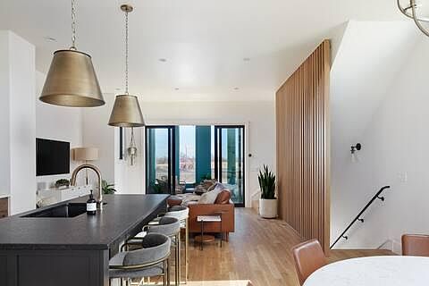 2nd floor - open concept main living room, dining, kitchen, and doors to outdoor covered terrace
