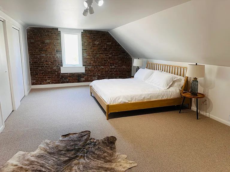 Large loft room with primary bedroom and ensuite bedroom.