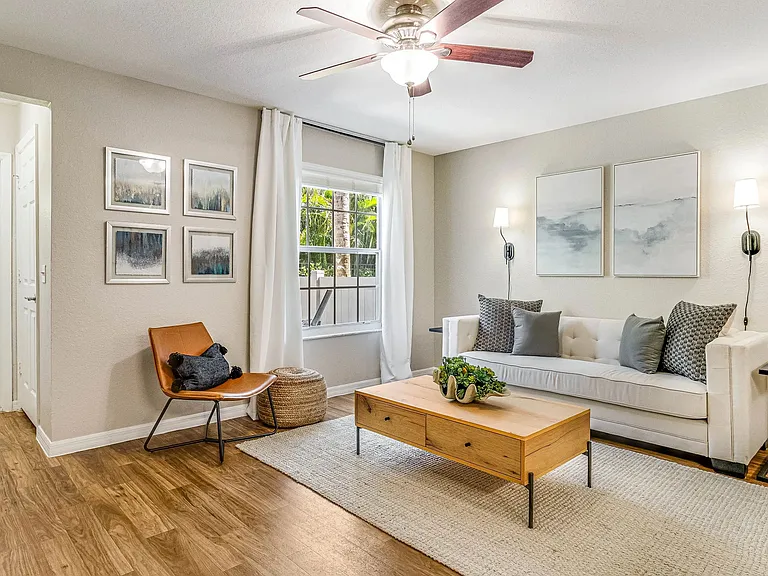 All living rooms epitomize breezy comforts with ceiling fans and large picture windows.