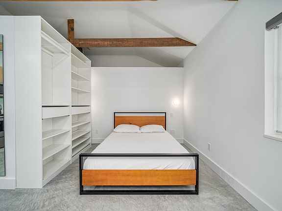 Two closet/drawer units and top & bottom hanger rods behind them in the cubby (not shown). Bed has switch activated wall lighting for reading in bed