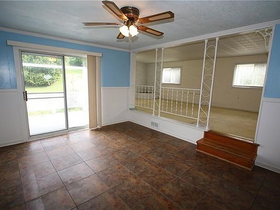 Newer Flooring in Formal Dining Room w/ Glass Sliding Door leading onto 30x8 Partially Cov'd Porch