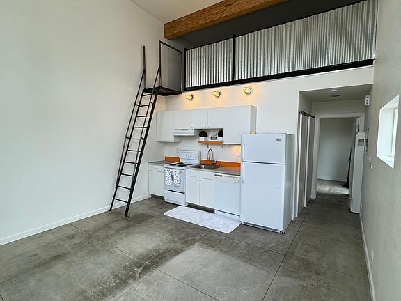 Kitchen and view of ladder to loft area
