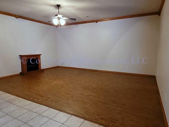 Living room with fireplace and ceiling fan