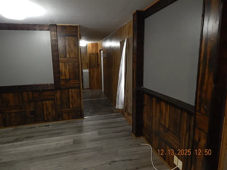 Living room looking to rear of home down hallway.-