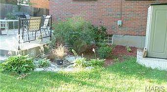 Back yard view with small pond and rose garden