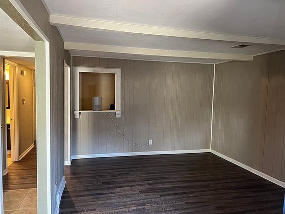 Living Room with vinyl luxury plank flooring, opening to desk area, or serving area, or