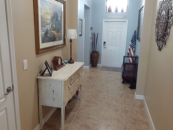 Foyer/hallway with coat closet near