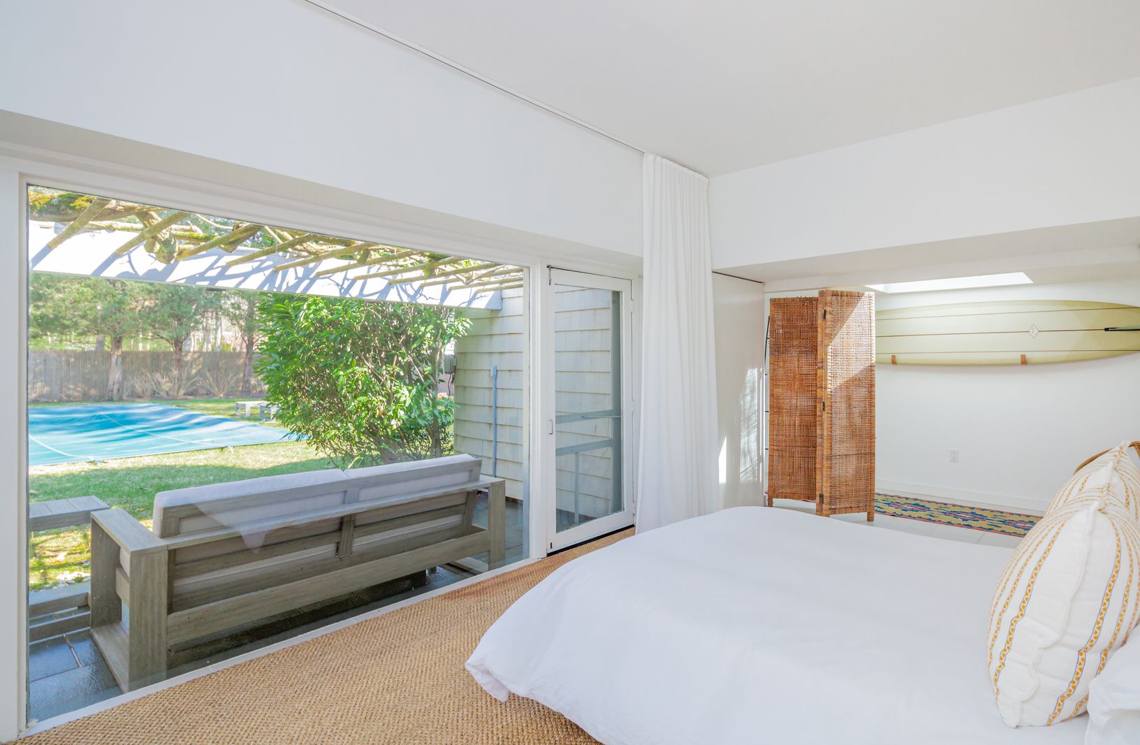  Guest house offers serene patio seating and is adjacent to fenced-in pool area.