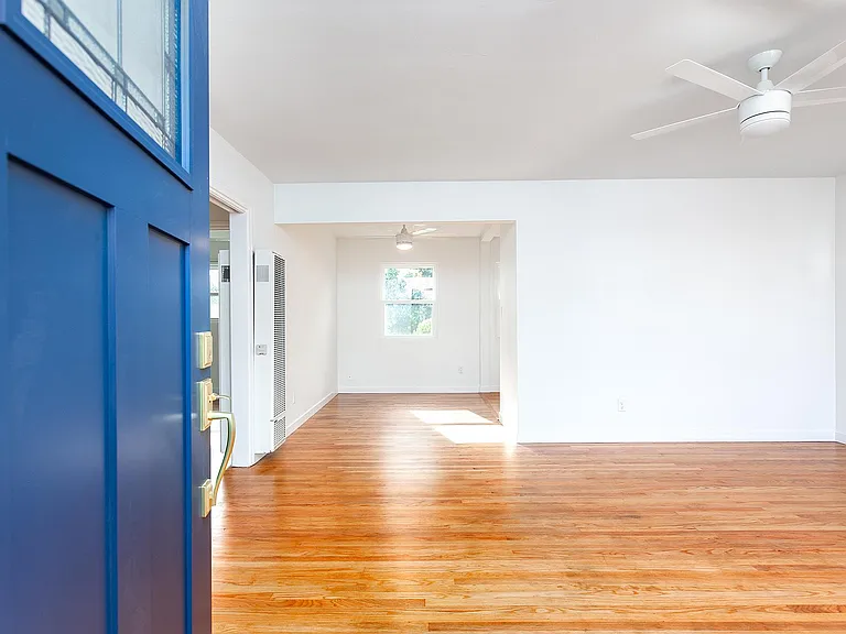 View from the front door into the living room and dining room in the distance. Kitchen is to the right of the dining room.