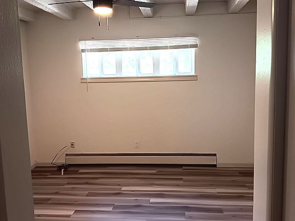 Bedroom with closet on right and door to kitchen on left,