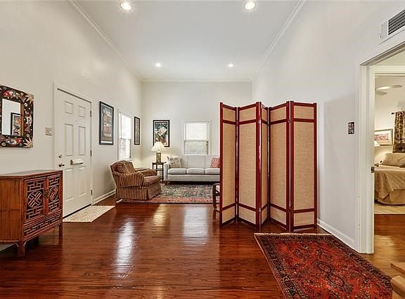 The GROUND floor unit has a MAGNIFICENT large LIVING area with GORGEOUS wood floors. Make it a dining room on one end, or make a second bedroom should you desire. SOARING ceilings and WINDOWS abound.