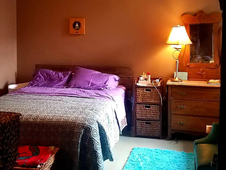 Peaceful, quiet bedroom w/ a large window that looks into the courtyard.