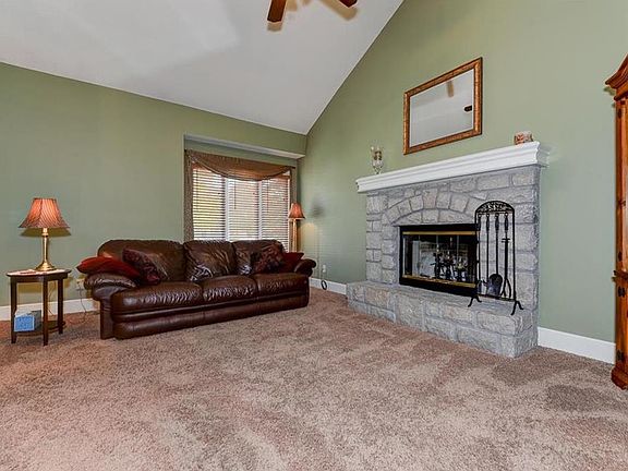 Living Room with Fireplace, Vaulted Ceiling & Fan