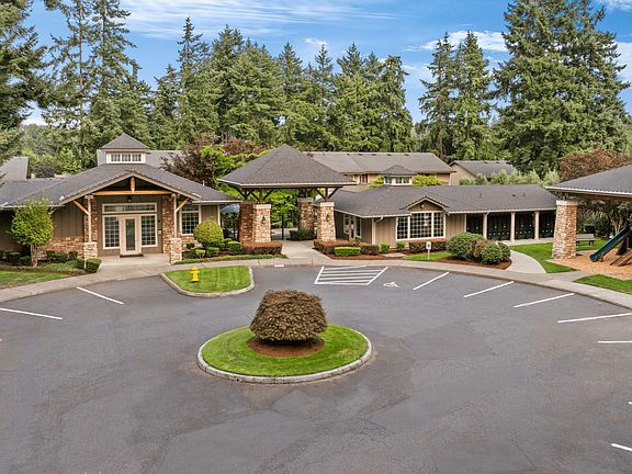 Welcoming clubhouse with stylish architecture and greenery.
