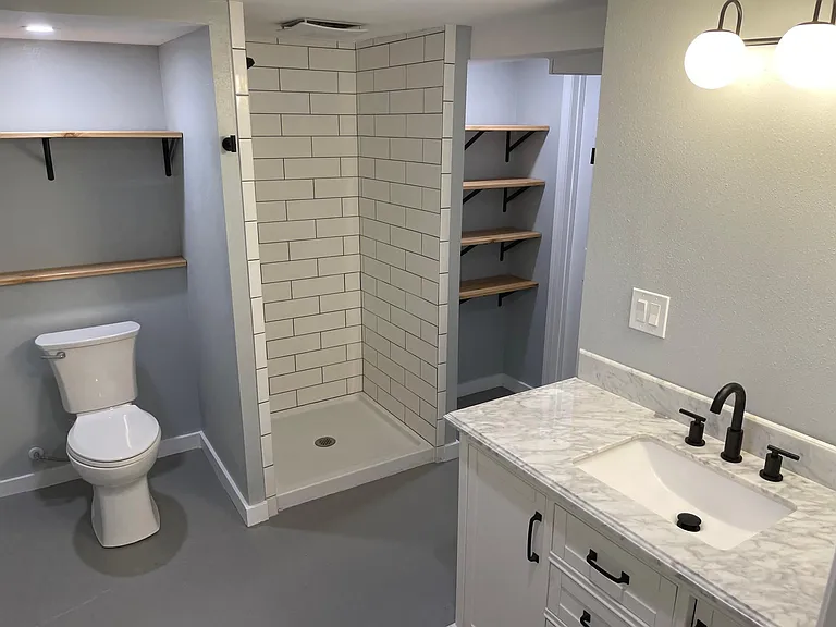 Extra large bathroom with full sized tiled shower with rain head, lots of linen and towel storage with room for two