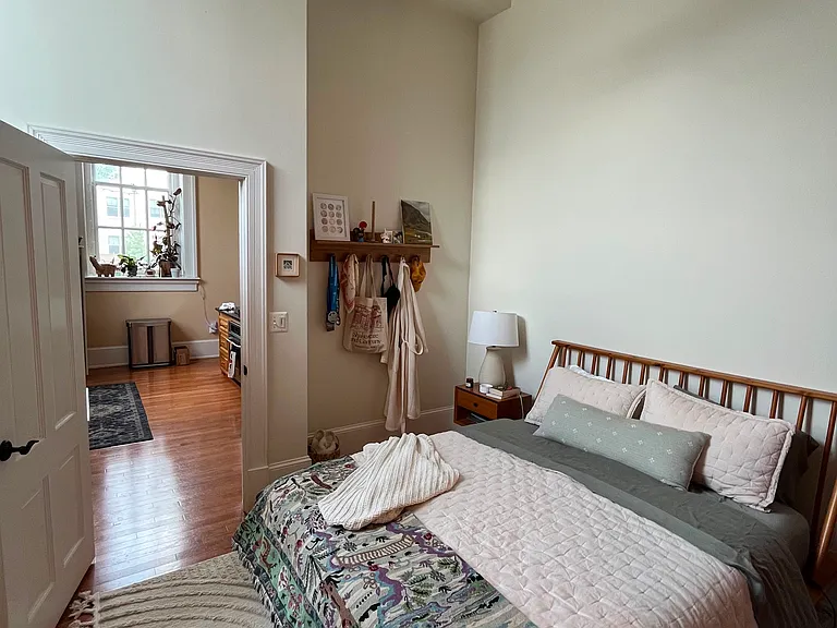 View of Master Suite with doorway entrance next to kitchen. Master main has 18 ft ceiling with ceiling fan. Bedroom large enough for a queen sized bed and comfortable movement plus nightstands.