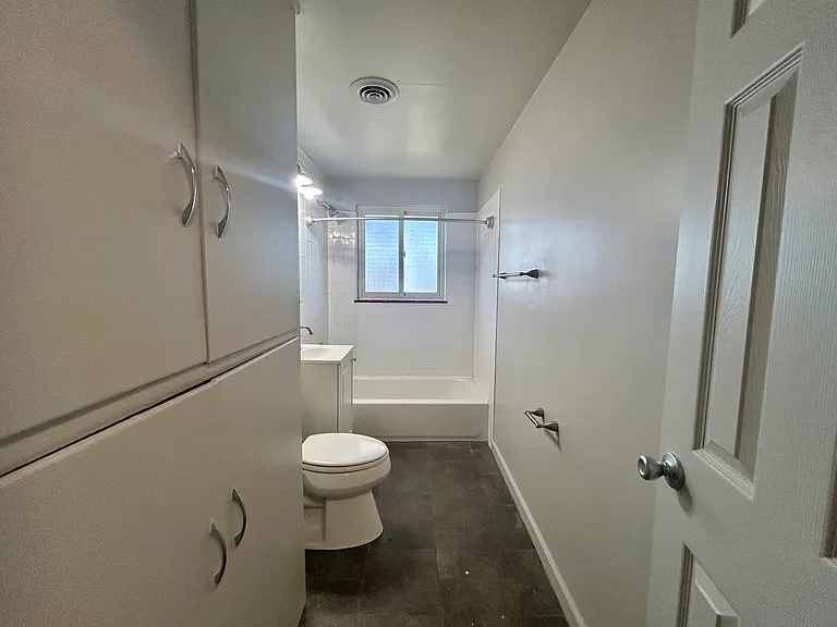 Bright and spacious bathroom featuring a sleek white design, modern fixtures, and ample storage space. Bright and spacious bathroom featuring a sleek white design, modern fixtures, and ample storage space.