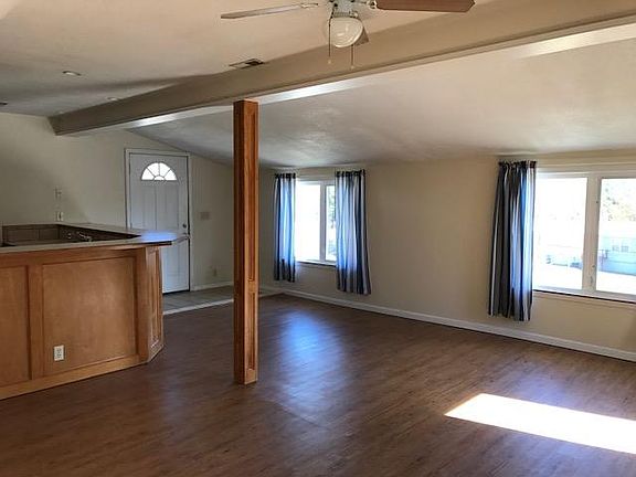 dining/living area open to kitchen; windows on two walls