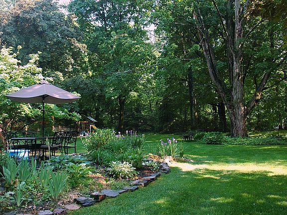 Parklike backyard with swingset